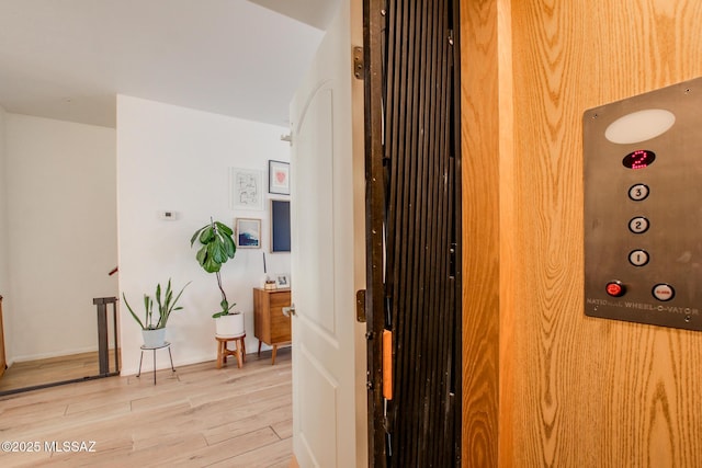 hallway with light hardwood / wood-style flooring