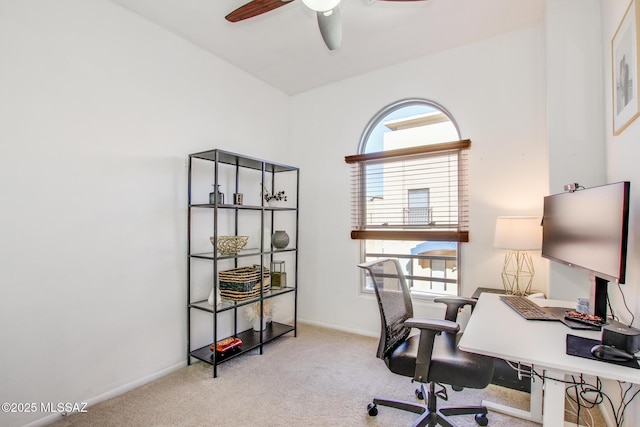 office space featuring light carpet and ceiling fan