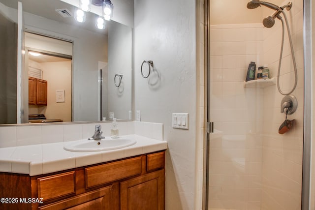 bathroom featuring vanity and a shower with door