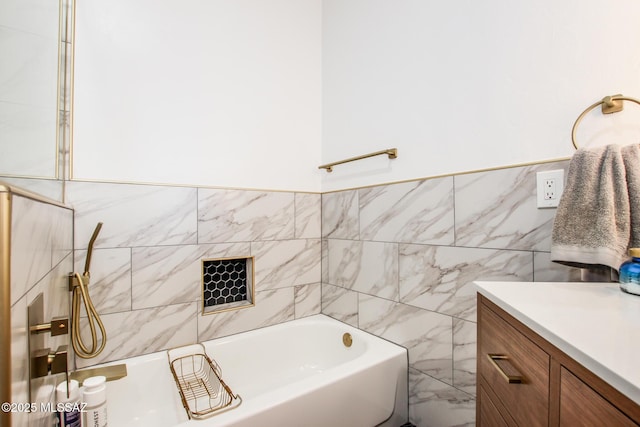 bathroom featuring tile walls, a washtub, and vanity