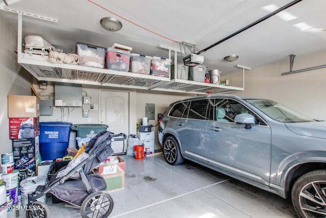 garage with a garage door opener and electric panel