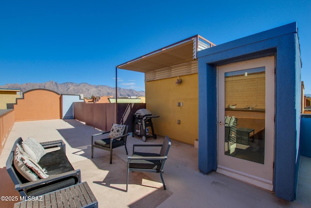 view of patio / terrace with a mountain view and grilling area