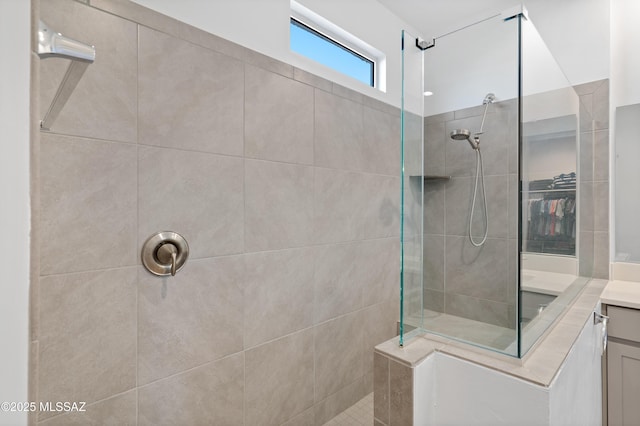 full bath featuring a walk in shower and vanity