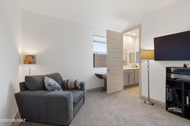 living room featuring light carpet and baseboards