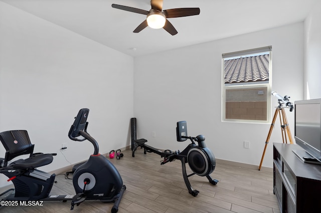 workout area with a ceiling fan, light wood-style flooring, and baseboards