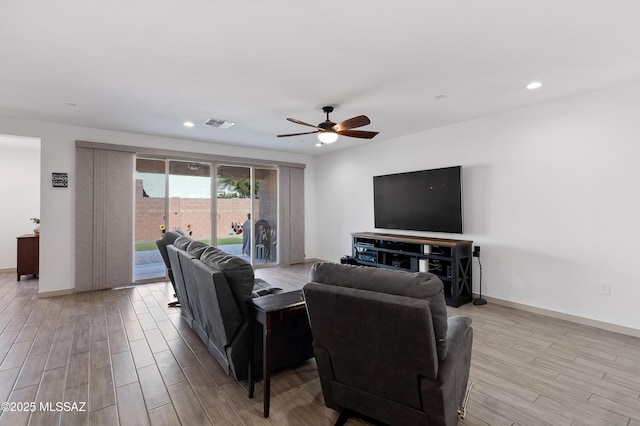 living room with a ceiling fan, recessed lighting, baseboards, and light wood finished floors