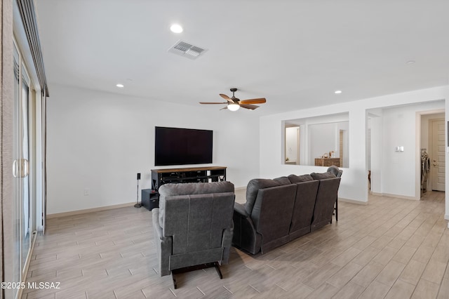 living area with recessed lighting, visible vents, wood tiled floor, ceiling fan, and baseboards