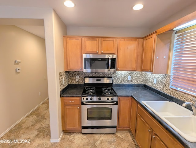 kitchen featuring decorative backsplash, sink, and appliances with stainless steel finishes