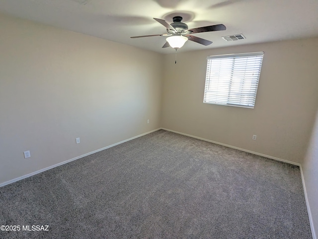 carpeted spare room with ceiling fan