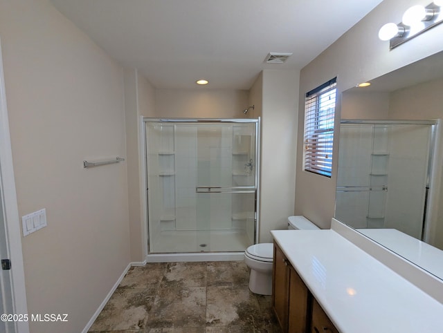 bathroom with toilet, walk in shower, and vanity