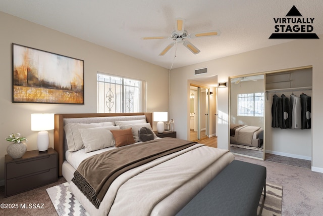 bedroom with ceiling fan, carpet flooring, and a closet