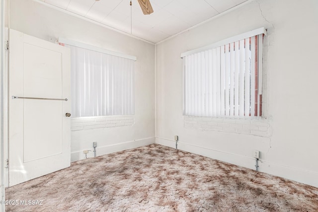 unfurnished room featuring carpet floors, ornamental molding, and ceiling fan