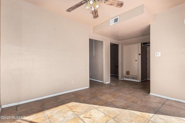 empty room featuring ceiling fan and light tile patterned floors