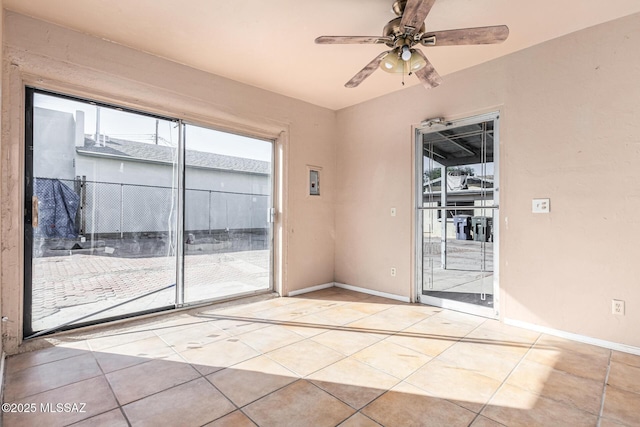 spare room featuring ceiling fan and light tile patterned floors