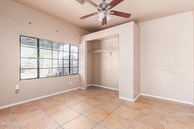 unfurnished bedroom featuring ceiling fan, a closet, and light tile patterned flooring