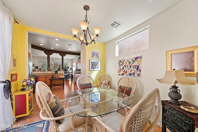 dining space with a notable chandelier and tile patterned floors