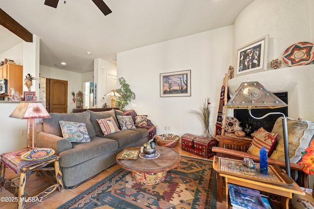 living room with ceiling fan, tile patterned flooring, and beam ceiling