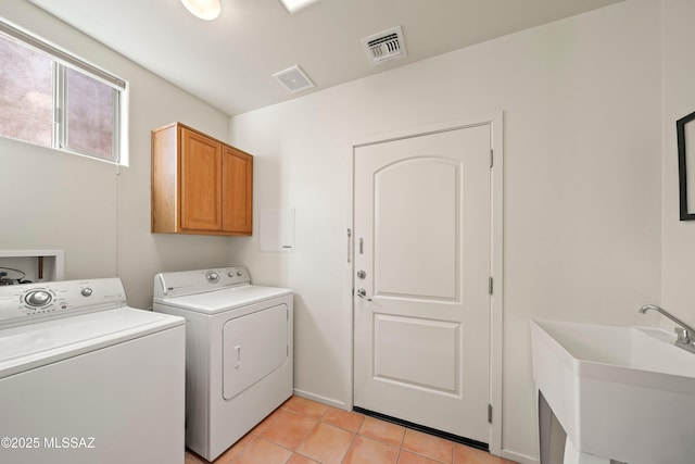 clothes washing area with cabinets, separate washer and dryer, sink, and light tile patterned flooring