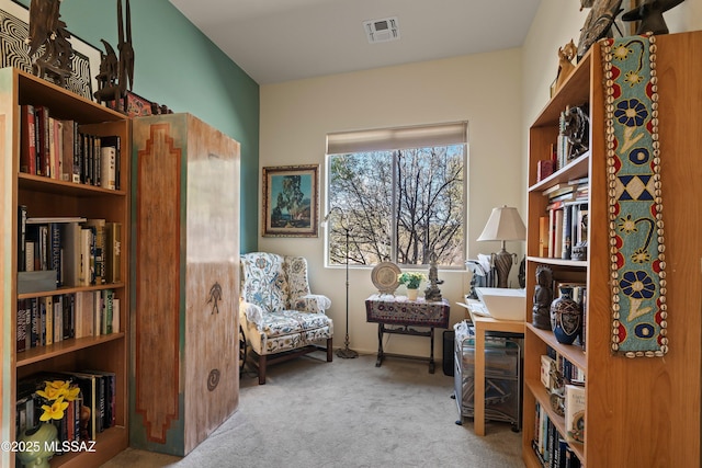 sitting room featuring light colored carpet