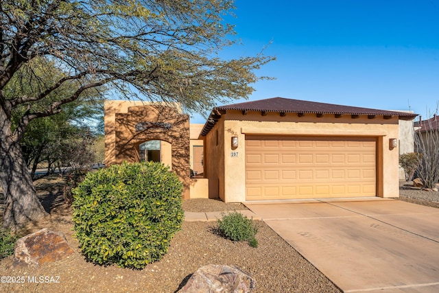 pueblo-style home featuring a garage