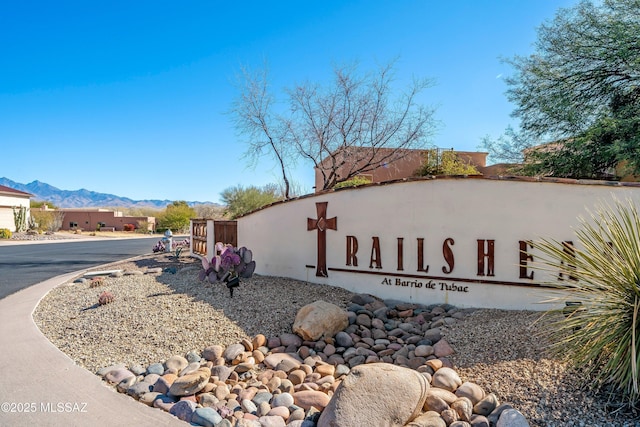 community / neighborhood sign with a mountain view