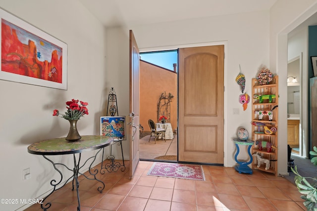 foyer entrance with light tile patterned floors