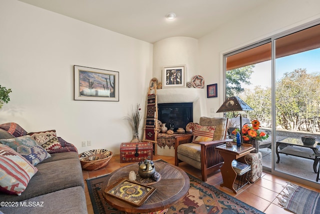 living room featuring light tile patterned floors and a fireplace