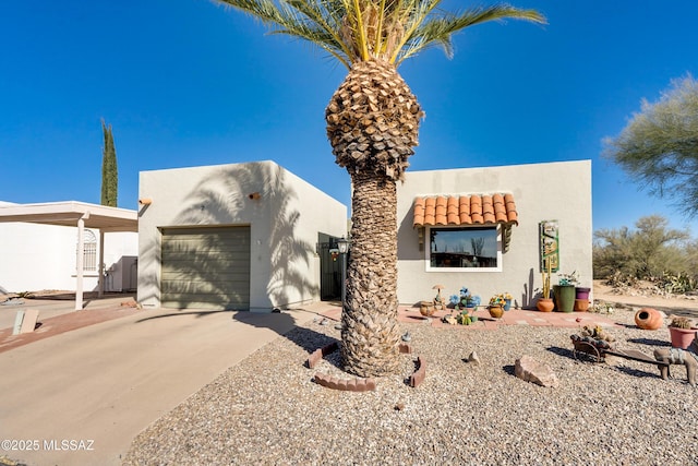 pueblo revival-style home with a garage