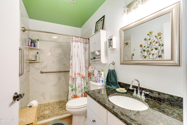 bathroom featuring walk in shower, vanity, and toilet