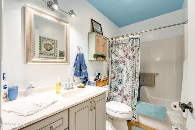 full bathroom featuring vanity, shower / bath combo with shower curtain, and toilet