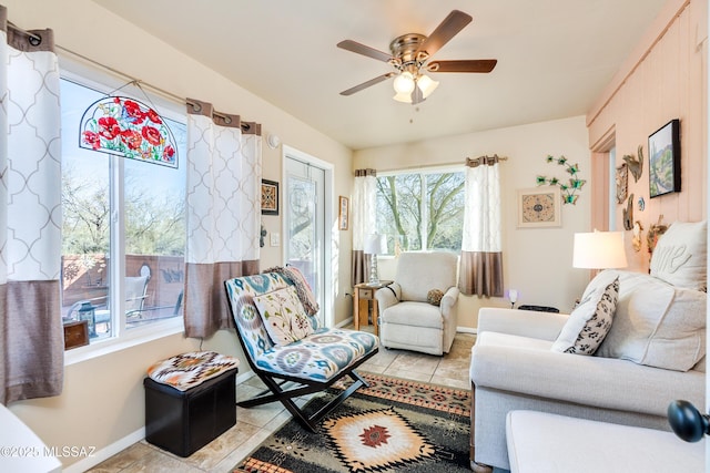 tiled living room with ceiling fan