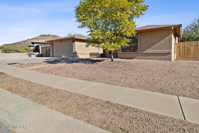 view of front of property featuring a garage and a mountain view