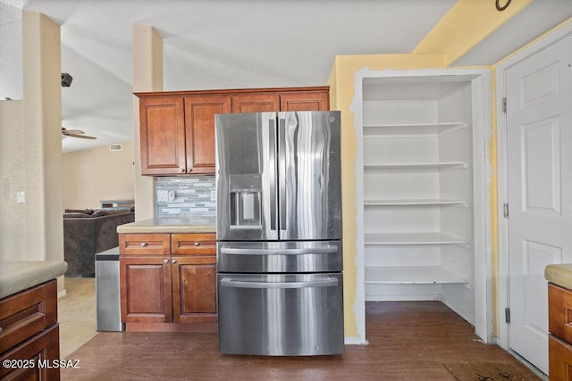 kitchen featuring ceiling fan, decorative backsplash, and stainless steel fridge with ice dispenser