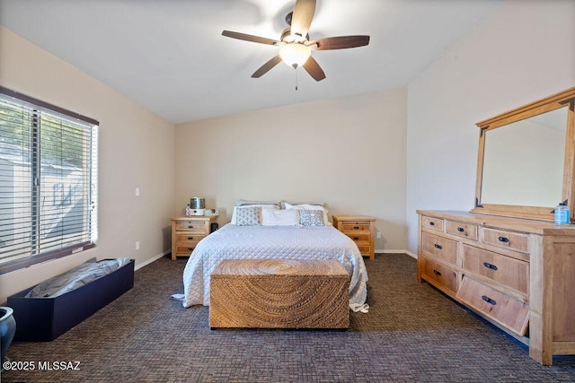 bedroom featuring ceiling fan and dark carpet