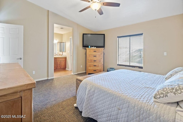 bedroom with ceiling fan, ensuite bathroom, and vaulted ceiling