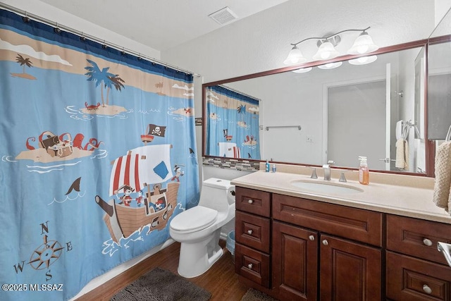 bathroom with toilet, a shower with curtain, wood-type flooring, and vanity