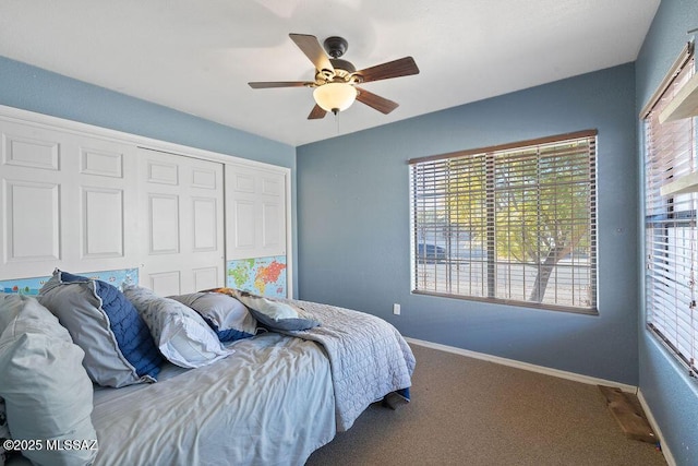 bedroom with ceiling fan, carpet, and a closet