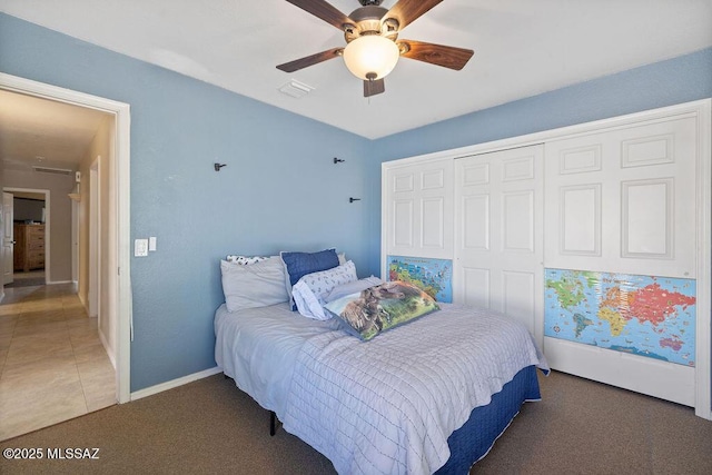 bedroom featuring ceiling fan, a closet, and dark carpet