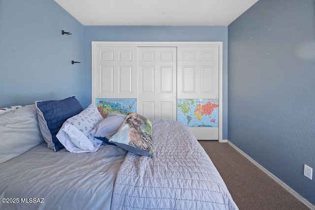 bedroom featuring vaulted ceiling, a closet, and carpet flooring