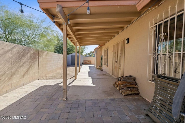 view of patio / terrace with a storage shed