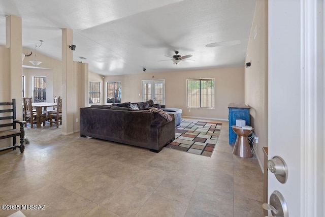 living room with ceiling fan and lofted ceiling