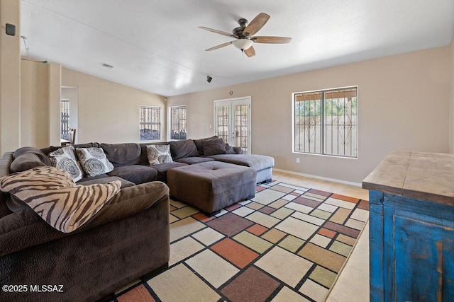 living room with ceiling fan, lofted ceiling, and french doors