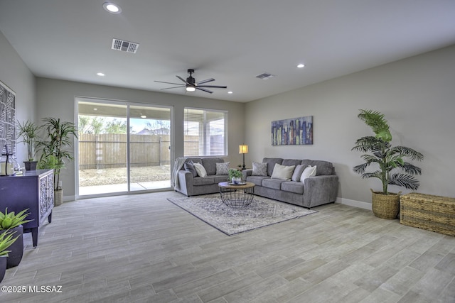 living room featuring ceiling fan and light wood-type flooring