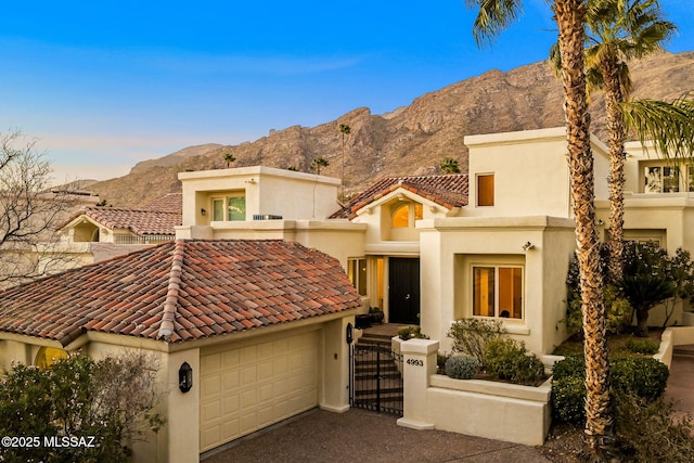 view of front facade with a garage and a mountain view