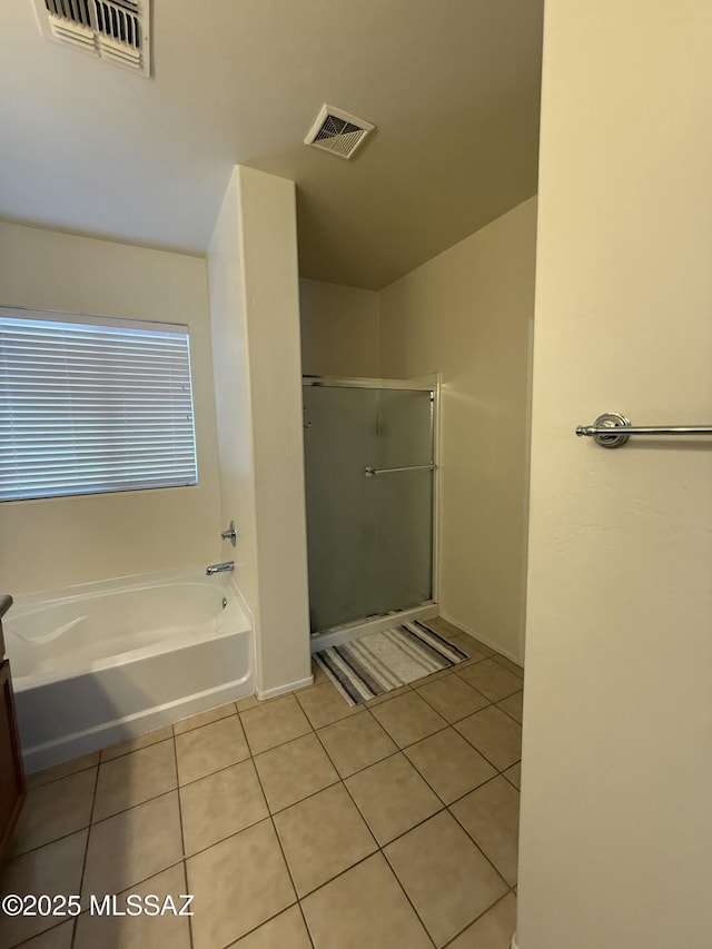 bathroom featuring shower with separate bathtub, vanity, and tile patterned flooring