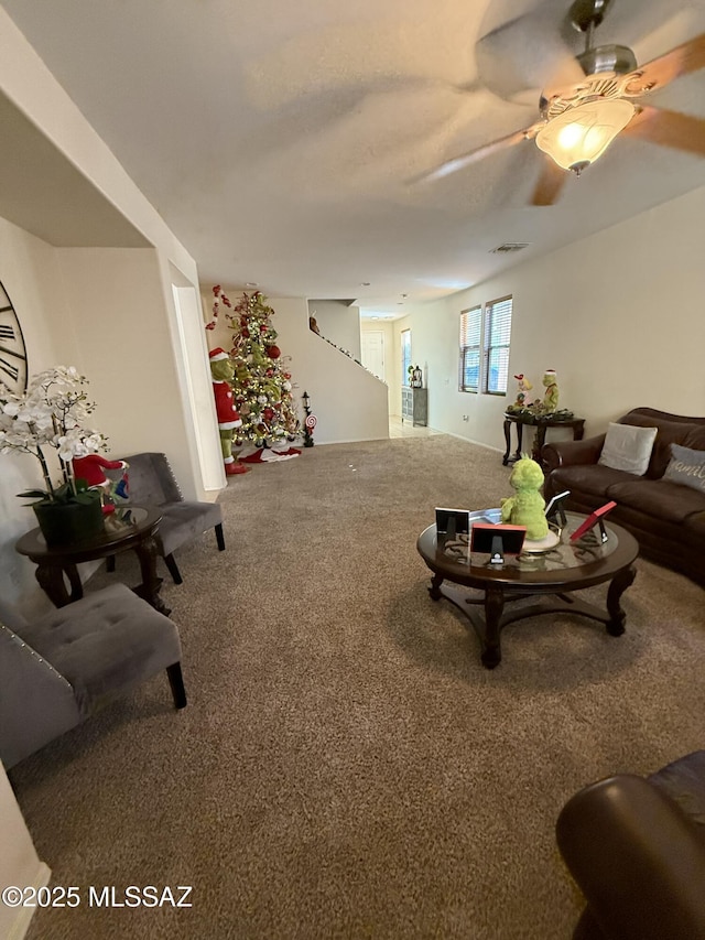 living room featuring ceiling fan and carpet flooring