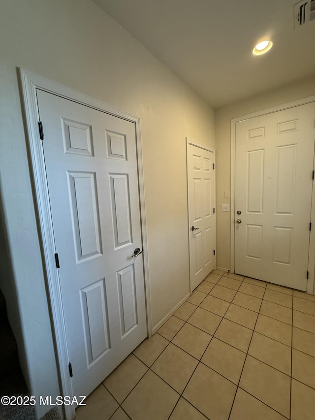 hallway with light tile patterned floors