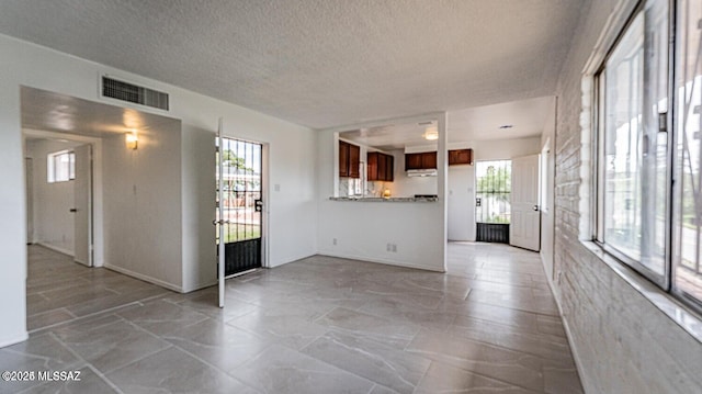 unfurnished living room with a healthy amount of sunlight