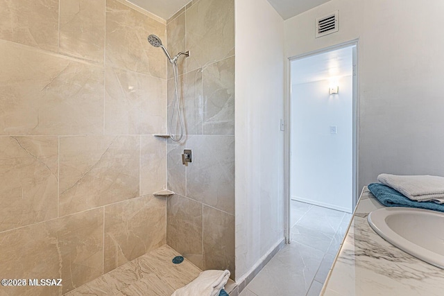 bathroom featuring vanity and tiled shower