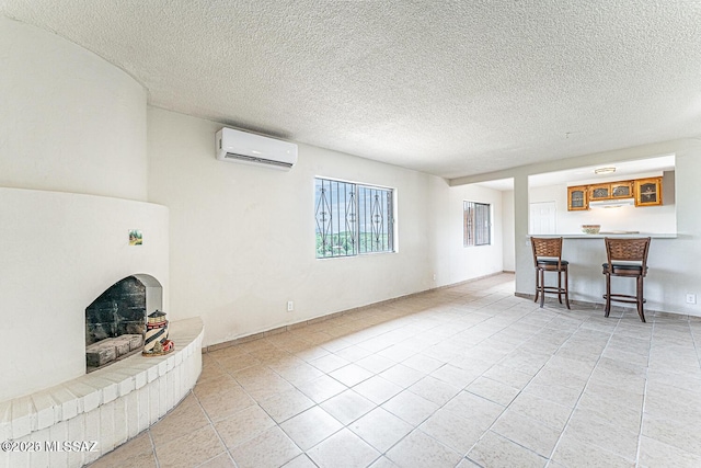 living room featuring an AC wall unit and a textured ceiling